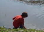child by water’s edge